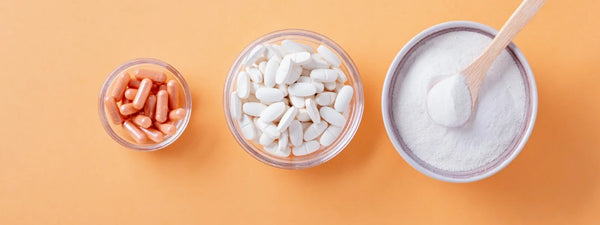 A healthy woman holding Wellbeing Nutrition's multivitamin tablets for women in her hand.