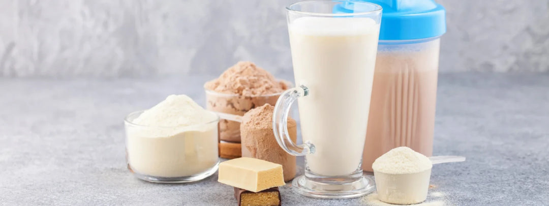 Chocolate milk protein powder with a scoop on a table 