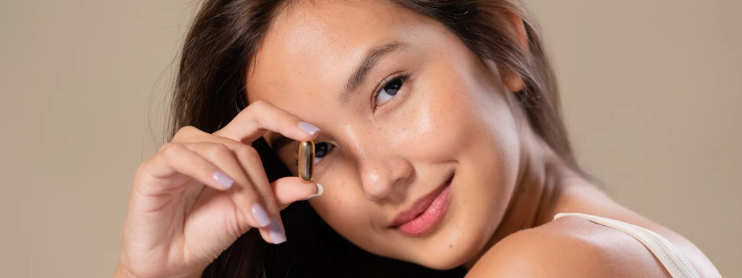 Multivitamin capsules and fruits representing healthy skin nutrition. 